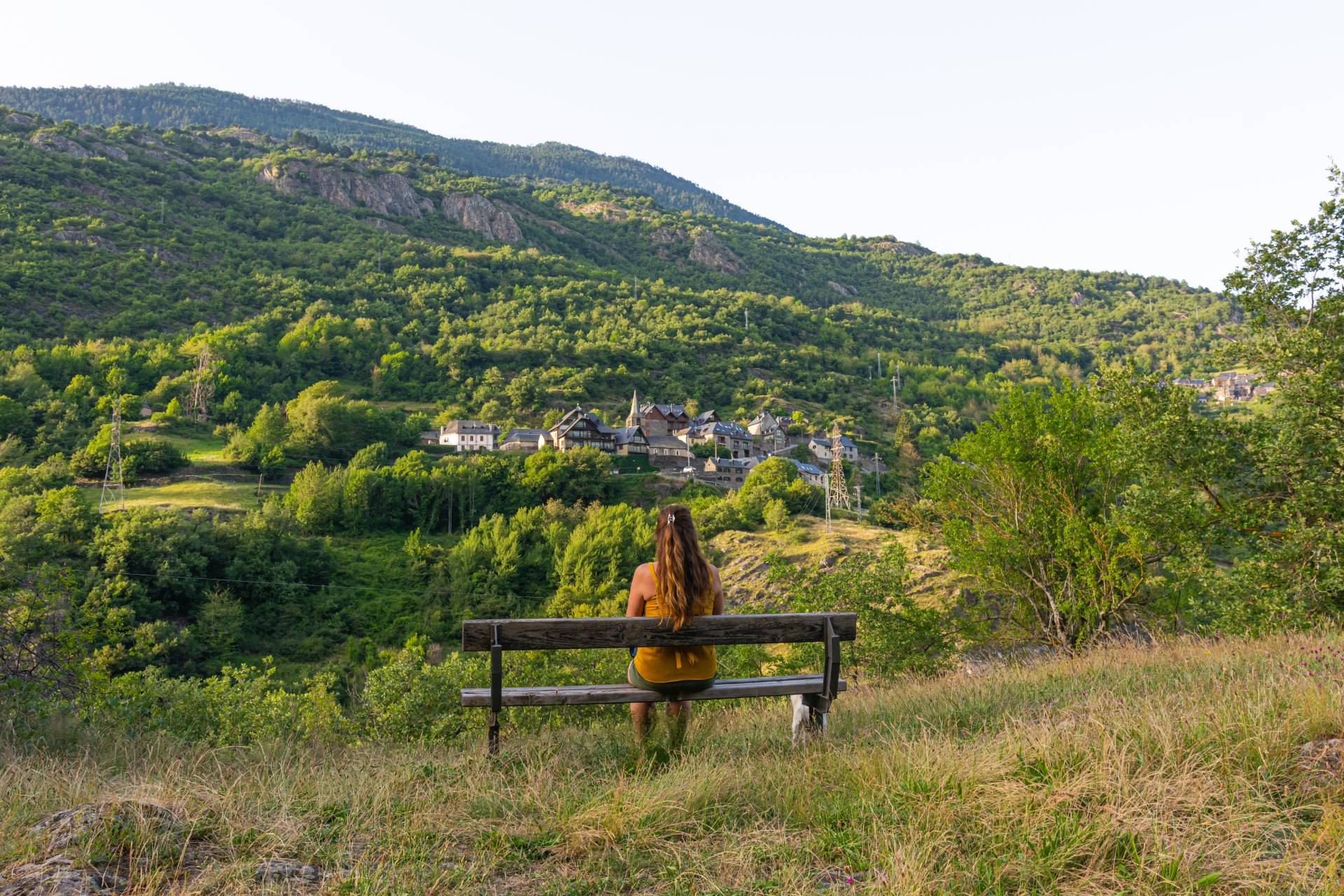 01_Allgemein/schoner-schuss-einer-frau-die-auf-der-bank-sitzt-die-eine-berglandschaft-gegenuberstellt.jpg
